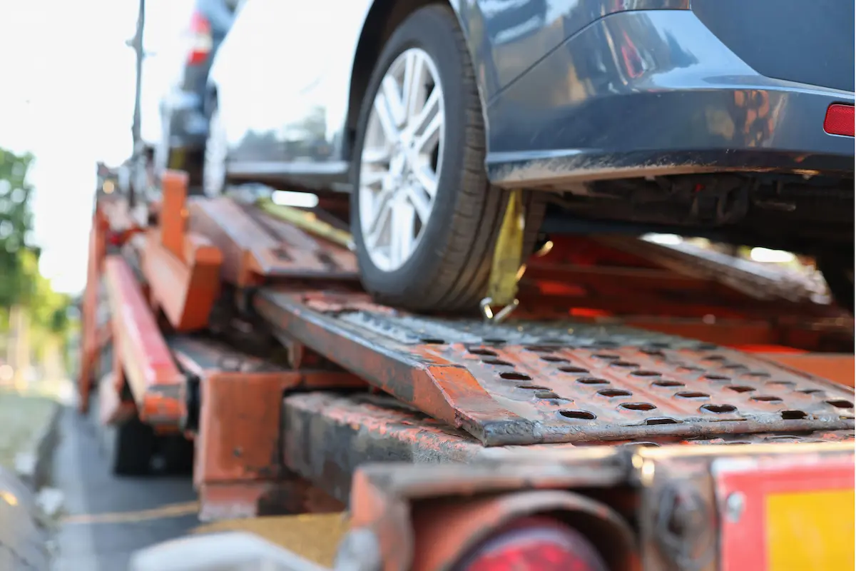 Car being towed in Malta by a recovery truck after illegal parking