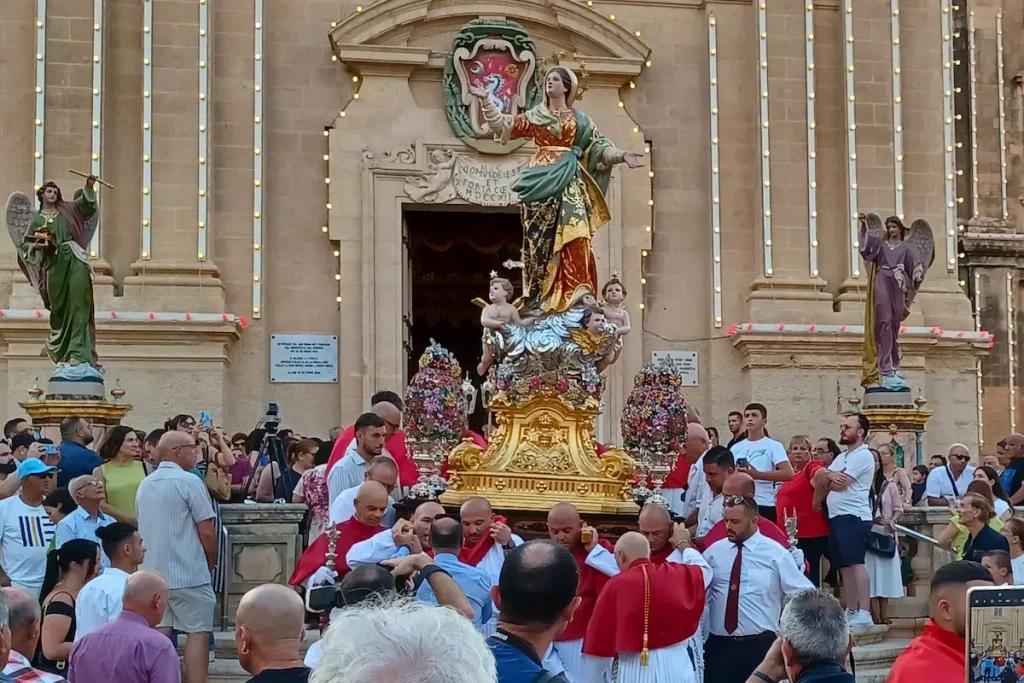 A statue of the Virgin Mary emerges from the church during the Santa Marija procession in Malta